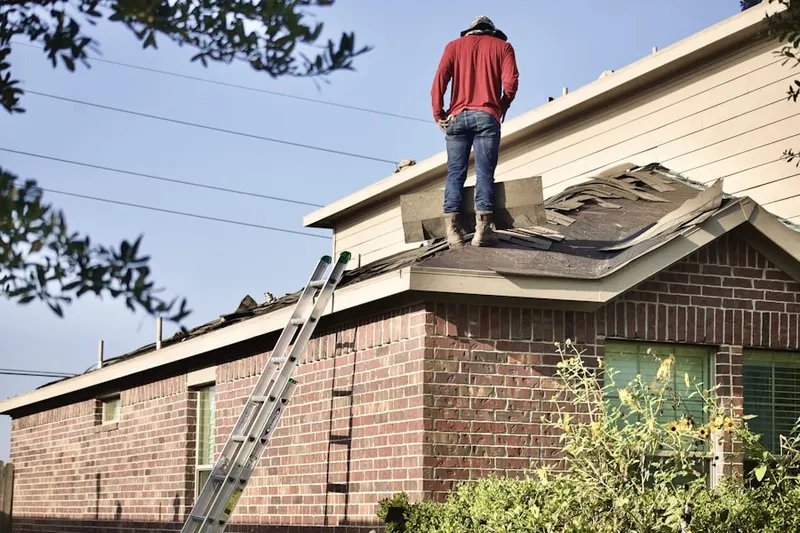 Professional roofer working on a residential roof in Downtown Fort Meade